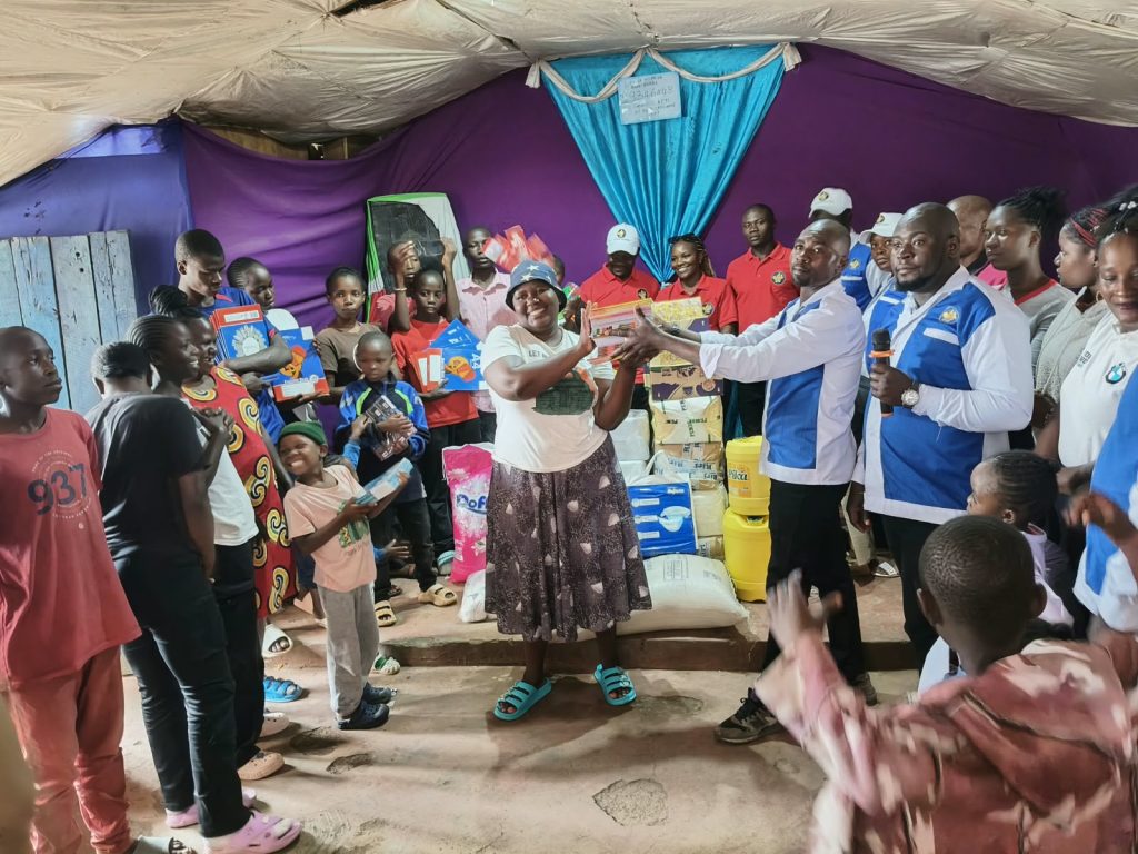 Families receiving food and supplies at the Community Outreach Day, October 2026